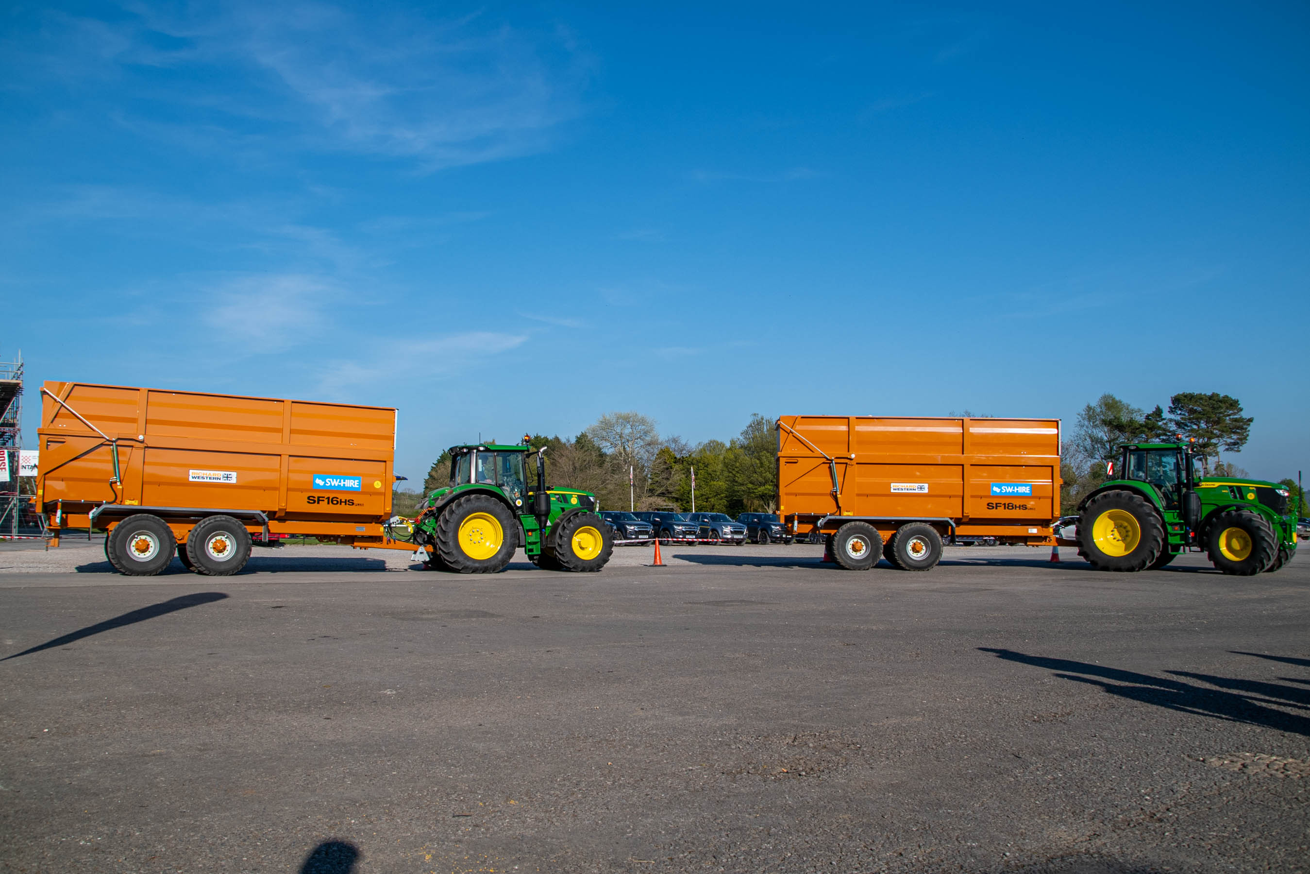 John Deere M Series tractors pulling SW Hire silage trailers at Bath and West Showground